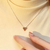 Angel Heart lab-grown diamond necklace styled on a cream turtleneck